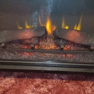 A fire place with speaker surround sound bar